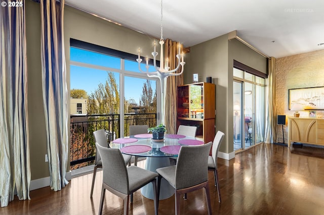 dining area with an inviting chandelier, a wealth of natural light, and dark hardwood / wood-style floors