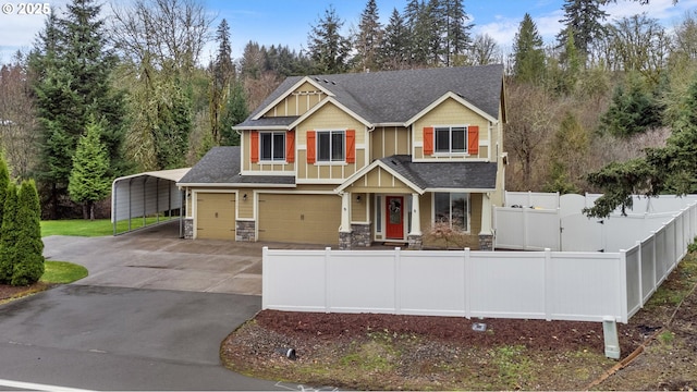 craftsman house with driveway, a fenced front yard, stone siding, roof with shingles, and a garage