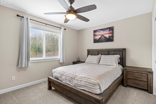 carpeted bedroom featuring a ceiling fan and baseboards