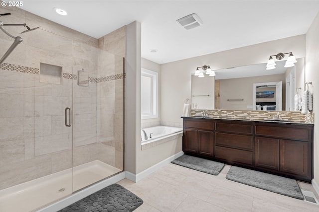 bathroom with a shower stall, a garden tub, double vanity, and a sink