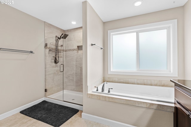 bathroom featuring vanity, baseboards, recessed lighting, a stall shower, and a garden tub