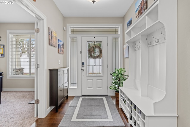 mudroom with dark wood-type flooring and baseboards