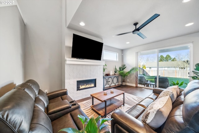 living room featuring ceiling fan and hardwood / wood-style floors