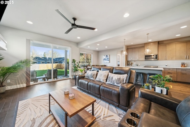 living room featuring dark hardwood / wood-style floors and ceiling fan