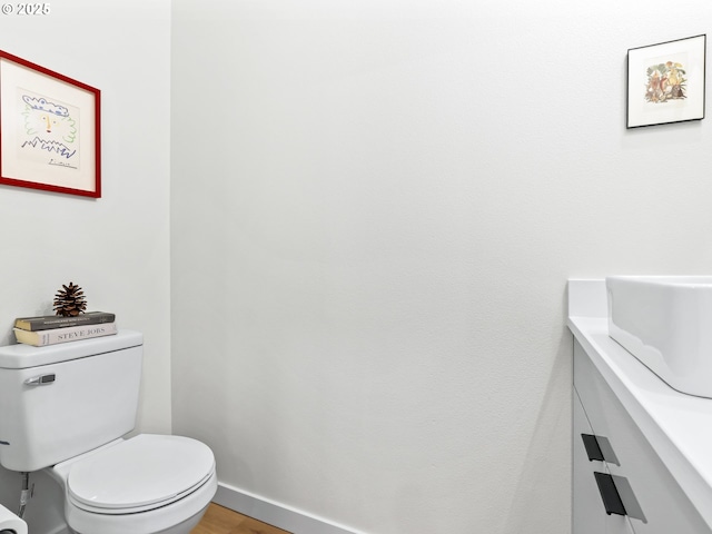 bathroom featuring hardwood / wood-style floors, toilet, and sink