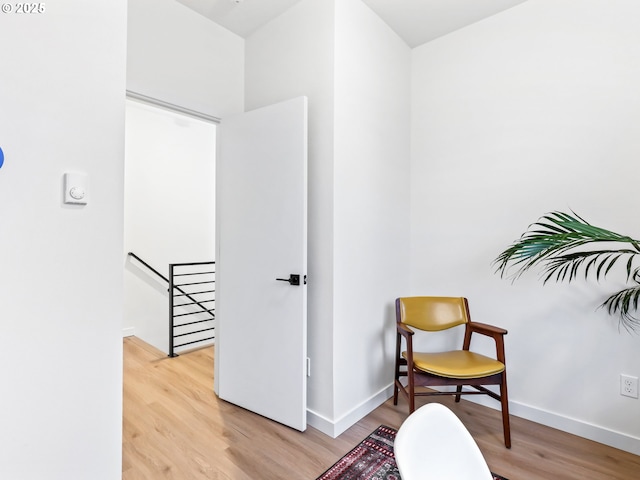 sitting room with hardwood / wood-style flooring