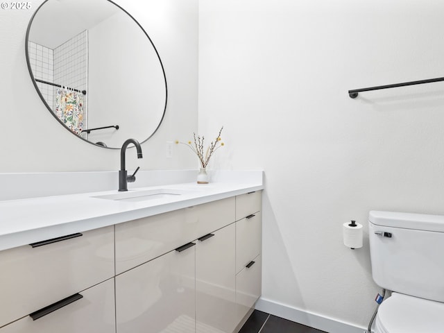 bathroom with tile patterned floors, curtained shower, vanity, and toilet