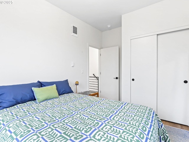 bedroom with hardwood / wood-style floors and a closet