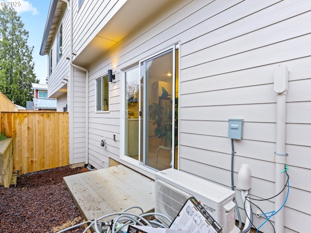 view of side of home featuring ac unit