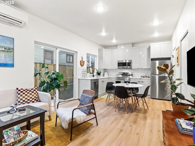 interior space featuring a wall unit AC and light hardwood / wood-style floors