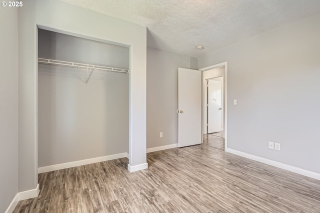 7217 NE 130th Ave, Vancouver, WA 98682 - unfurnished bedroom featuring wood finished floors, a closet, baseboards, and a textured ceiling