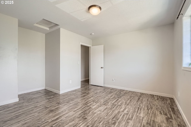 7217 NE 130th Ave, Vancouver, WA 98682 - spare room with wood finished floors, attic access, and baseboards