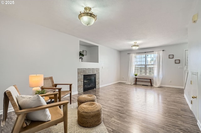 7217 NE 130th Ave, Vancouver, WA 98682 - living room featuring wood finished floors, baseboards, and a fireplace