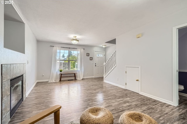 7217 NE 130th Ave, Vancouver, WA 98682 - living room featuring wood finished floors, stairway, baseboards, and a fireplace
