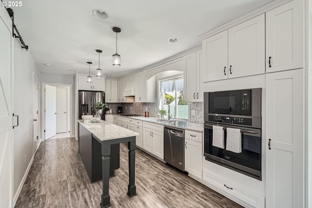 7217 NE 130th Ave, Vancouver, WA 98682 - kitchen featuring stainless steel appliances, tasteful backsplash, premium range hood, arched walkways, and white cabinetry