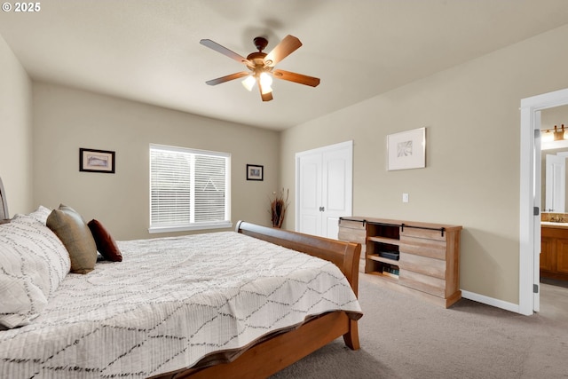 carpeted bedroom with ceiling fan and connected bathroom