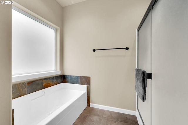 bathroom with tile patterned flooring and a bathtub