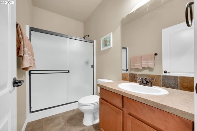 bathroom with vanity, tile patterned floors, a shower with door, and toilet