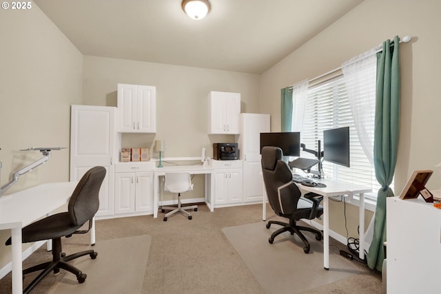 carpeted office space with lofted ceiling