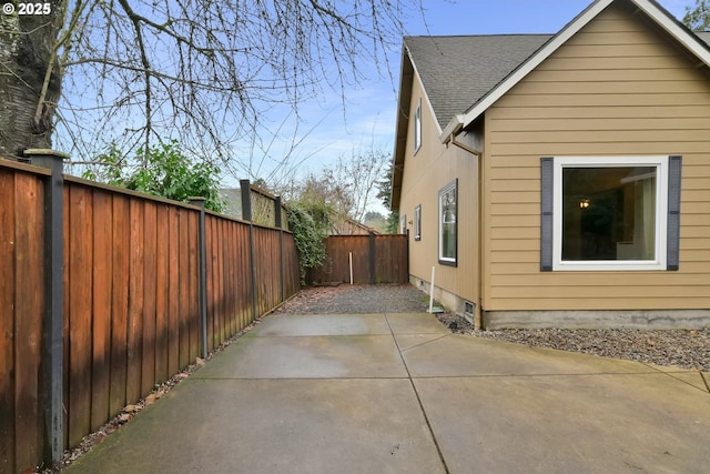 view of side of home with a patio area