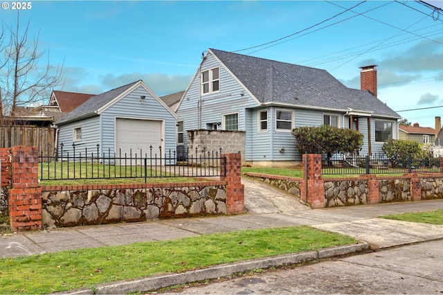 cape cod house with a fenced front yard, an outdoor structure, driveway, and a shingled roof