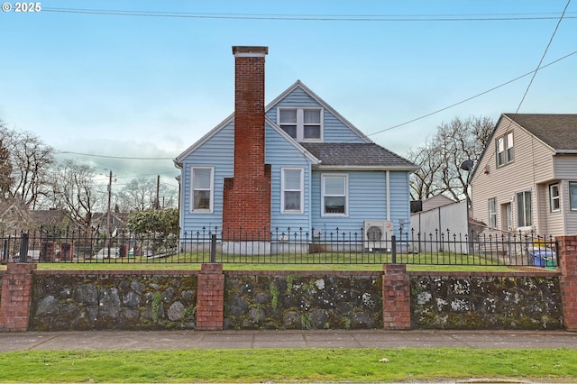 bungalow-style home with a fenced front yard, roof with shingles, and a chimney