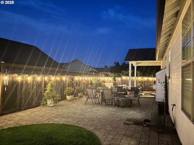 4120 Stellar Way, Springfield, OR 97478 - patio at night featuring a patio, a fenced backyard, and outdoor dining area