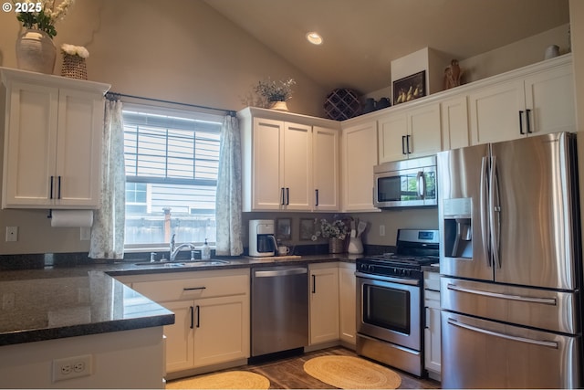 4120 Stellar Way, Springfield, OR 97478 - kitchen featuring appliances with stainless steel finishes, a sink, lofted ceiling, white cabinets, and plenty of natural light