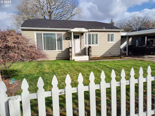 bungalow-style house featuring an attached carport, fence, and a front lawn