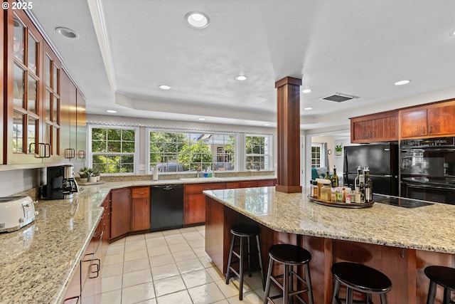 415 W Madrone St, Roseburg, OR 97470 - kitchen with black appliances, a kitchen bar, plenty of natural light, glass insert cabinets, and recessed lighting