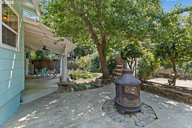 415 W Madrone St, Roseburg, OR 97470 - fenced backyard with ceiling fan, a fire pit, and a patio