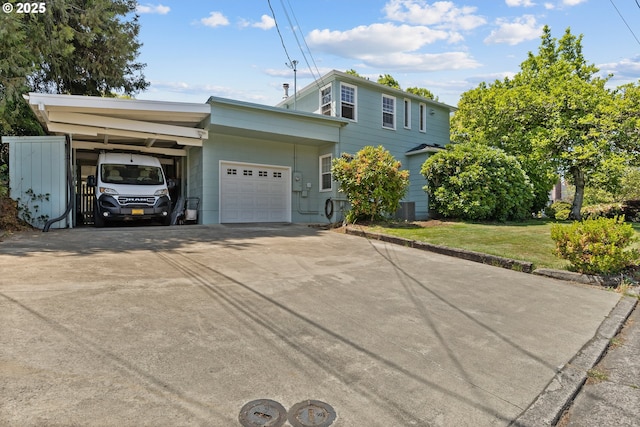 415 W Madrone St, Roseburg, OR 97470 - view of front of house featuring a carport, concrete driveway, a front lawn, and a garage