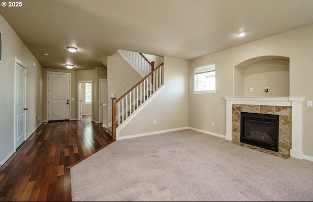 unfurnished living room with dark hardwood / wood-style flooring and a fireplace