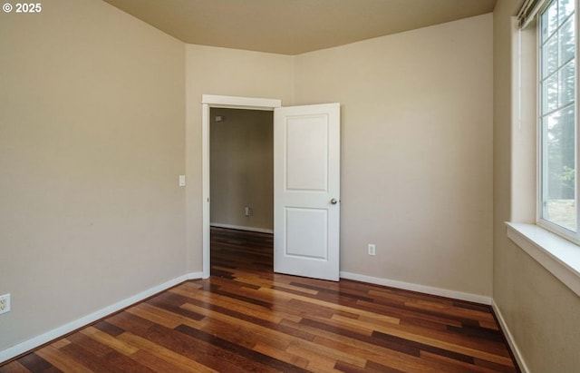 empty room featuring dark wood-type flooring