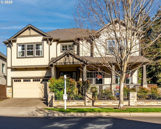 craftsman inspired home with board and batten siding, covered porch, fence, a garage, and concrete driveway