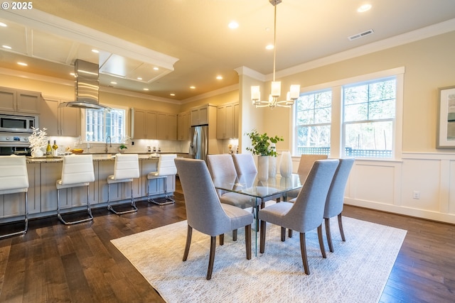 dining space with ornamental molding, visible vents, and dark wood-type flooring