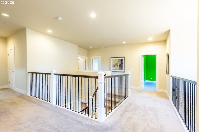 hall with recessed lighting, carpet flooring, and baseboards