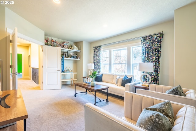 living room with light carpet and a textured ceiling