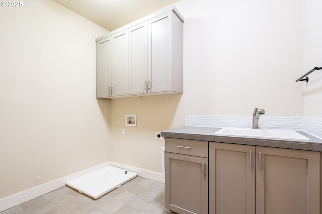 laundry area with baseboards, washer hookup, a sink, hookup for an electric dryer, and cabinet space