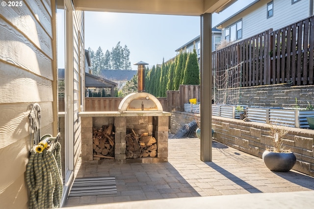 view of patio with fence and an outdoor kitchen