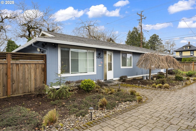 7450 N Portsmouth Ave, Portland, OR 97203 - view of front of house with fence, decorative driveway, and a shingled roof