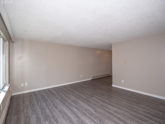 7450 N Portsmouth Ave, Portland, OR 97203 - unfurnished room featuring a baseboard heating unit, dark wood finished floors, baseboards, and a textured ceiling