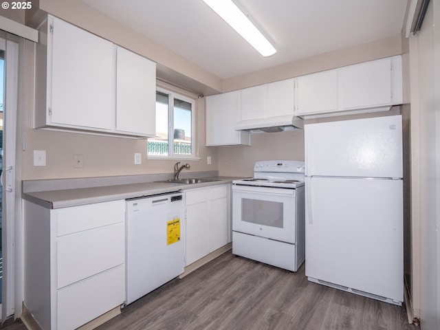 7450 N Portsmouth Ave, Portland, OR 97203 - kitchen featuring white cabinets, under cabinet range hood, wood finished floors, a sink, and white appliances