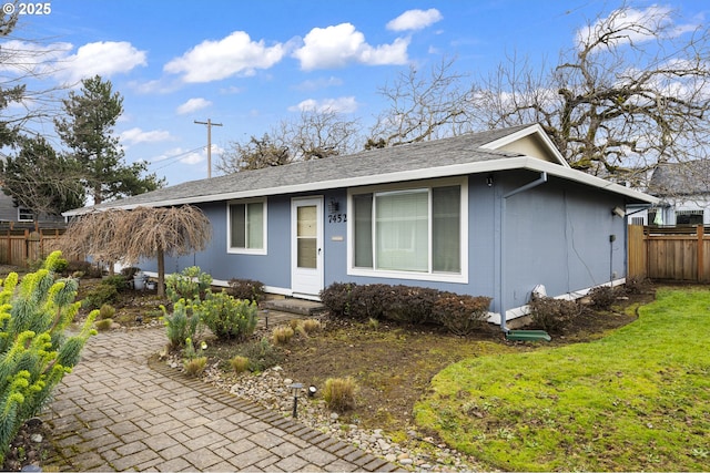 7450 N Portsmouth Ave, Portland, OR 97203 - ranch-style home featuring a shingled roof and fence