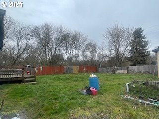 view of yard with fence and a wooden deck