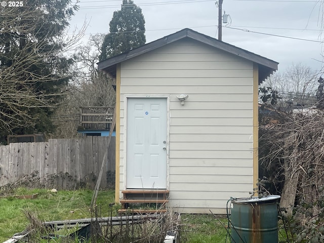 view of shed with entry steps and fence