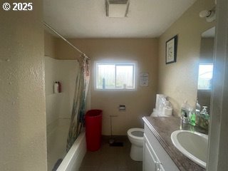 bathroom with toilet, curtained shower, visible vents, and vanity