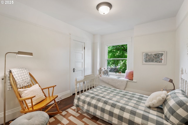 bedroom with baseboards and wood finished floors