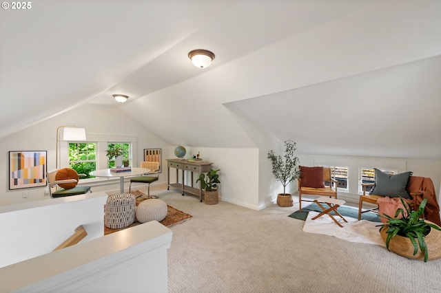 carpeted living room featuring vaulted ceiling
