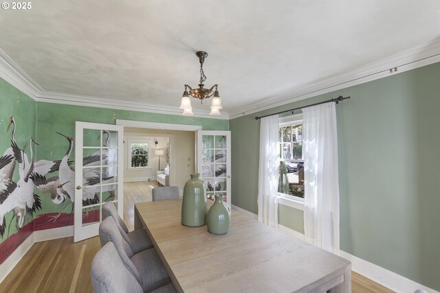 1805 SW Elizabeth St, Portland, OR 97201 - dining area with a chandelier, crown molding, baseboards, and wood finished floors